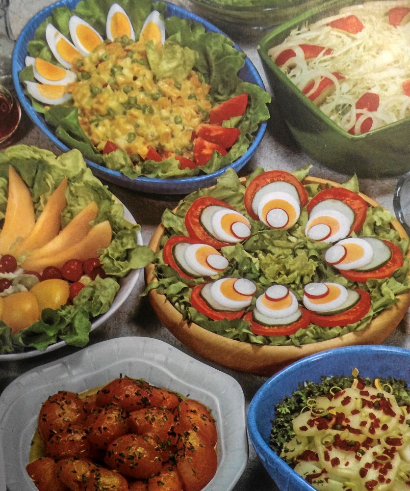 På 1960-talet kunde man konsten att lägga upp vackert. Här var det inte frågan om att planlöst kasta ihop en grönsallad. På fatet i mitten syns grönsallad med tomat, gurka, ägg och rädisskivor, i precis den ordningen.