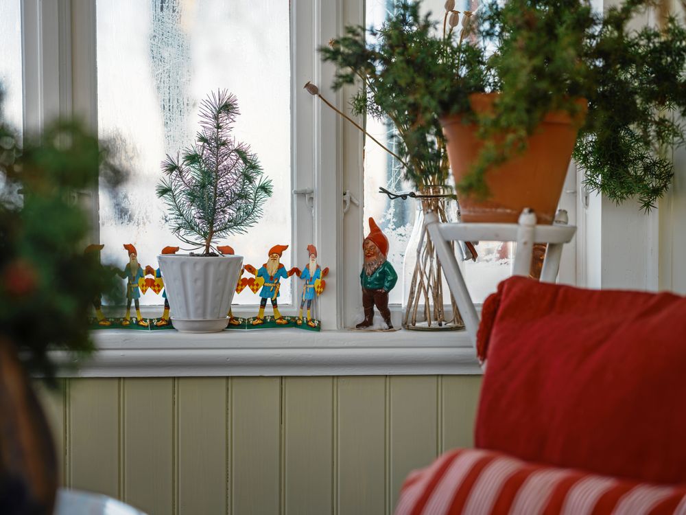 Fina pappers- och keramiktomtar från 1940- till 1960-talen pryder även förstugans fönster.