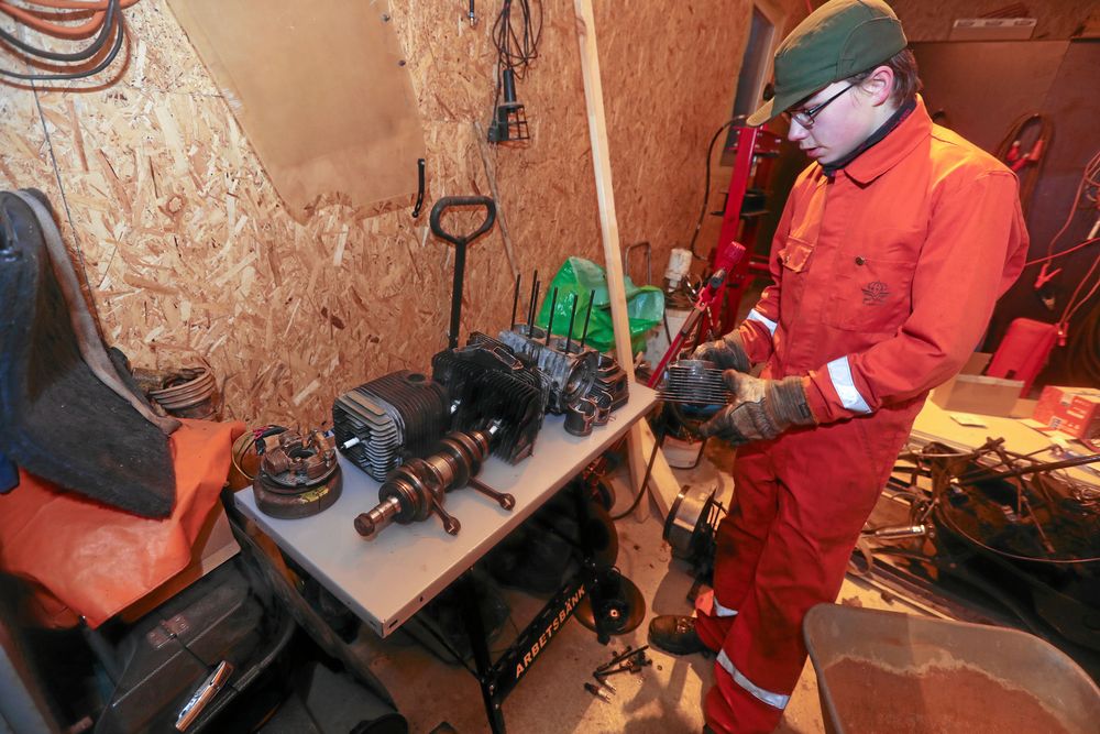 I ett av garagen på föräldrarnas gård har han plockat ned en hel motor som han är i färd med att totalrenovera.