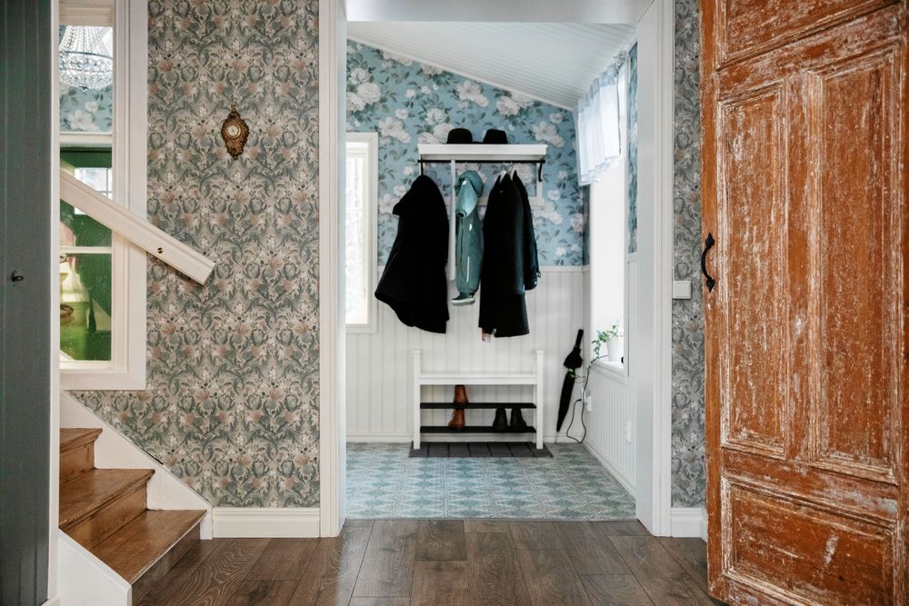 Vid tröskeln till den nya hallen slutar det gamla torpets vägg.